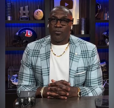 a man in a white shirt and a plaid blazer
