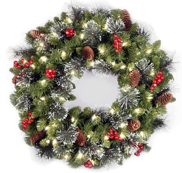 Christmas wreath with berries, pincones, and some leaves with snow