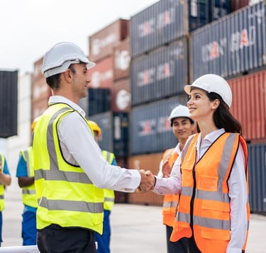 a man and woman shaking hands in front of a container container