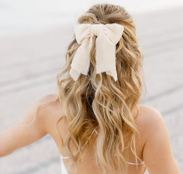 Blonde fashionista bride wears short wedding dress, silk hair bow and natural hair extensions