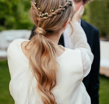 Bride with effortless natural ponytail decorated with natural flowers during wedding in Portugal