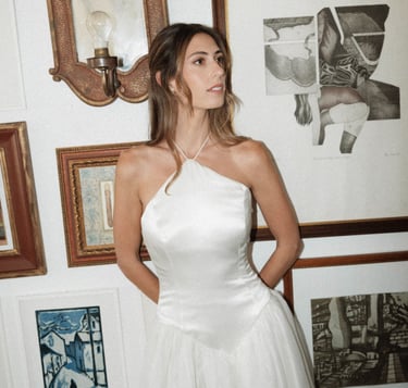 Bride with a simple half uo half down hairstyle showcasing her elegant dress by Nous Nous