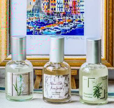 a variety of different scent fragrances and a framed picture of ships in the background