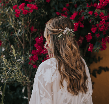 Half up half down wedding hairstyle with natural flowers Hugo Coelho Photography