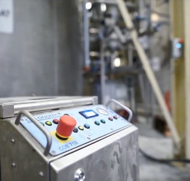 A CRYONOMIC COB 71R dry ice blasting machine being used for industrial cleaning in a factory facility.