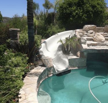 swimming pool with grotto and natural stone slide