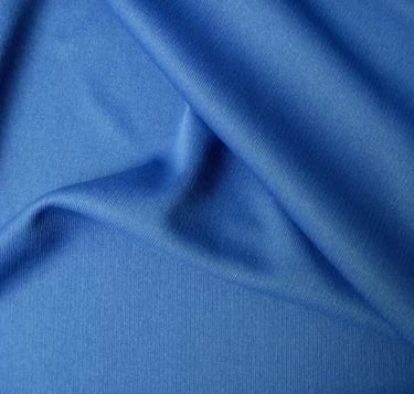 a blue fabric covered fabric with a plain background