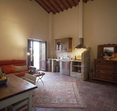 a living room with a couch and a kitchen