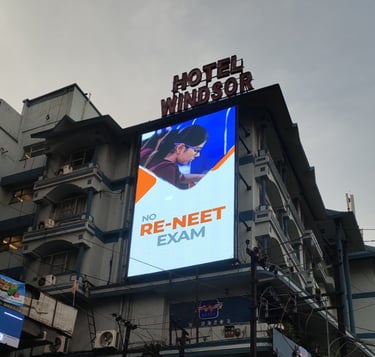 a large billboard board with a large advertisement on the side of a building