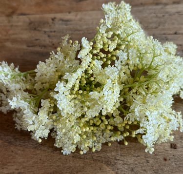 a bunch of white flowers on a wooden table