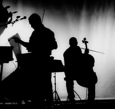 Silhouette of two male musicians, one of them holding a cello.