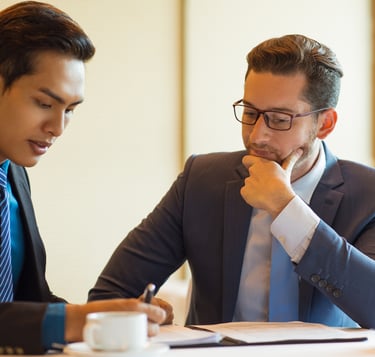 Two men engaged in interview coaching, discussing strategies and techniques to enhance job interview performance.