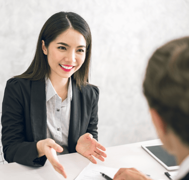 professional resume writer discussing with job applicant on how to improve his resume