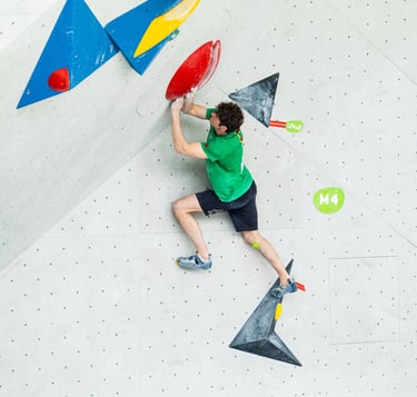 a man bouldering touching a hold with two hands