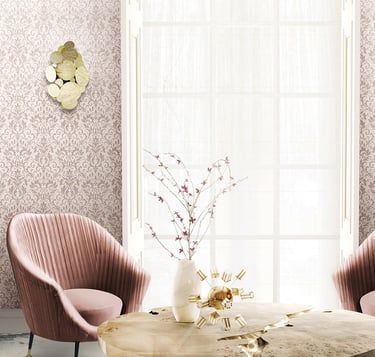Elegant living room featuring pink damask wallpaper, velvet armchairs, and luxury gold wall sconces.
