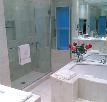 Luxury Glenview master bath featuring big soaking tub wall mirror, and glass walk-in shower