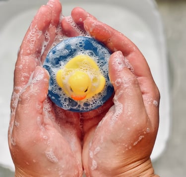 a person holding a custom made soap as a rubber duck in their hands