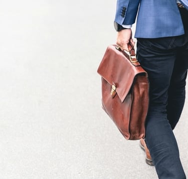 Terminated employee leaving work with briefcase seeking whistleblower retaliation lawyer
