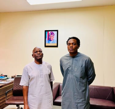 two men standing in a room with a couch and a couch