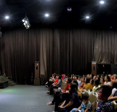 a large group of people standing in front of a stage