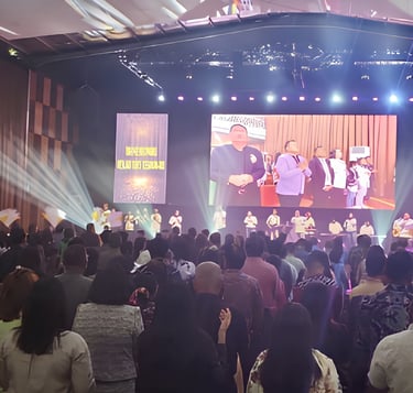 a large group of people standing in front of a stage