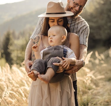 Mother and father holding their baby during an outdoor family photoshoot in the South Downs 