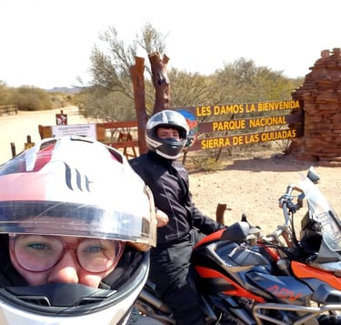 a man and woman on a motorcycle with helmets