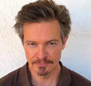 Headshot of Todd Long with medium-short hair, moustache, and goatee