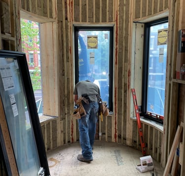 a man in a room with a window and a window