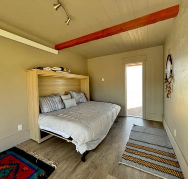 a bedroom with a bed and a bed in the corner