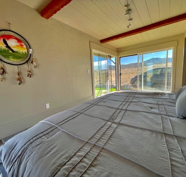 a bed with a large bed and a large window