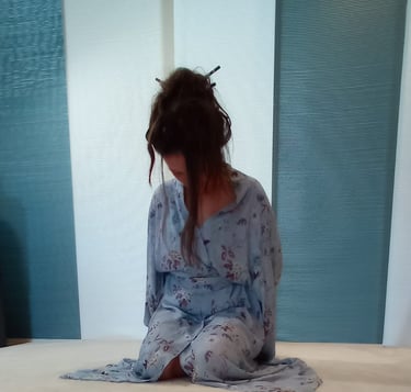 a woman in a blue dress sitting 