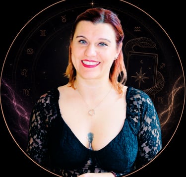 A smiling woman with red hair in a black lace top set against a mystical zodiac circle background.
