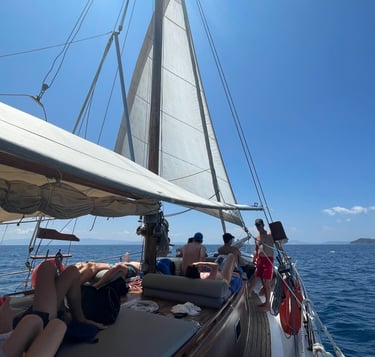 a group of people on a boat daily cruise in skiathos