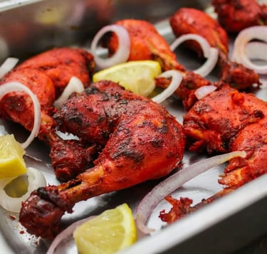 a tray of chicken wings with onions and onions