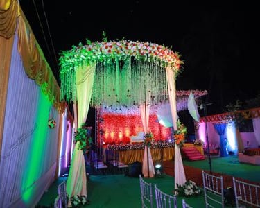 a decorated stage with a canopy tent and stage set up for a wedding