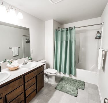 a bathroom with a green shower curtain and a green shower curtain