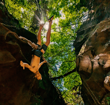 a man is doing a trick on a canyon rock climbing