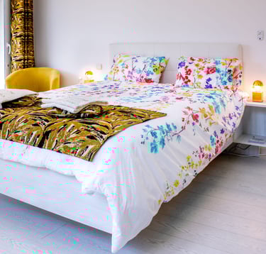 Bed with full bedding, floating bed with two with swimming pool in flower colours at Domaine Des Lucques