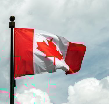 a canadian flag flying in the sky