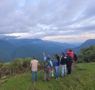 a group of people standing on a hill top