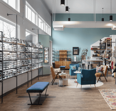 Interior showroom at Edge Optics Fort Collins location, with stylish seating and eyewear to shop