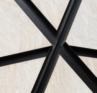 A sharp, editorial photograph of a modern Middle Eastern architectural detail. Sleek black steel intersecting with warm bone white limestone. The composition is clean, abstract, and exudes a sense of structured power and luxury.