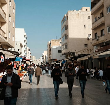Wide professional landscape of a bustling modern city street in Algiers, showing clean architecture and people using mobile devices. Sharp focus, daylight, vibrant energy, capturing the essence of a market in digital transition, North African / Algerian context.