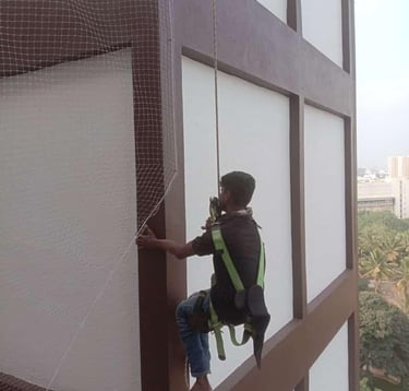 a technician installing duct nets for pigeons in bengaluru