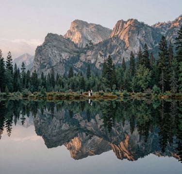A sophisticated nature shot of a North American / US mountain range during the blue hour. The style is clean and artistic, featuring deep Sage Green forests and Stone Khaki rock faces under a Mist White misty sky, reflecting the couple's appreciation for the natural world.