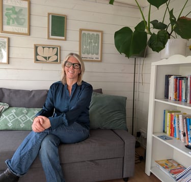 A picture of Alison Zorraquin, Counsellor, sitting on a sofa in the counselling practice