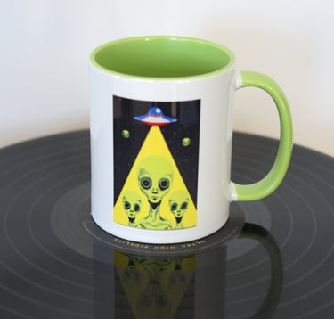 Aliens in beam from spaceship on mug 