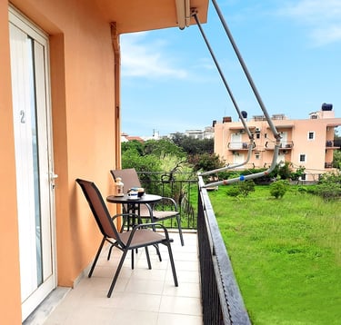 a balcony with a table and chairs and a balcony