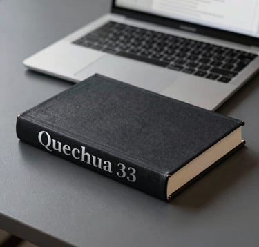 An elegant, minimalist shot of a high-quality hardcover book with 'Quechua' in silver leaf lettering on the spine, resting on a charcoal grey desk. In the background, a modern laptop is open to a translation interface. Sharp focus and prestigious lighting.